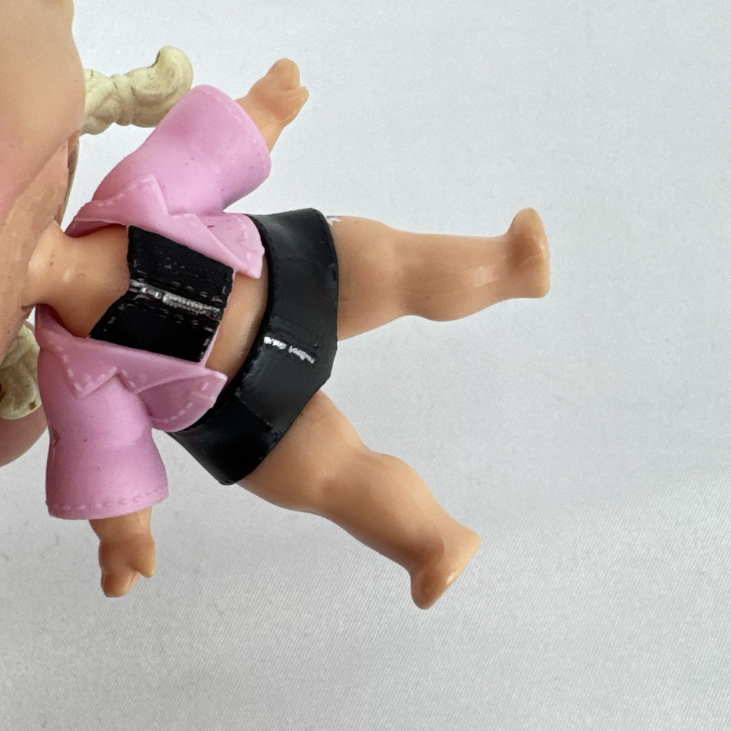 MGA L.O.L. Surprise! Biker Babe 3-inch doll with blonde sculpted hair, pink moto jacket, and MOM heart tattoo