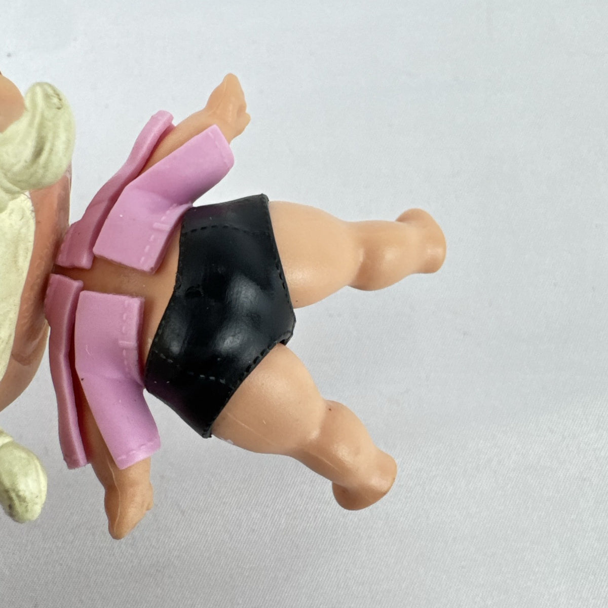 MGA L.O.L. Surprise! Biker Babe 3-inch doll with blonde sculpted hair, pink moto jacket, and MOM heart tattoo