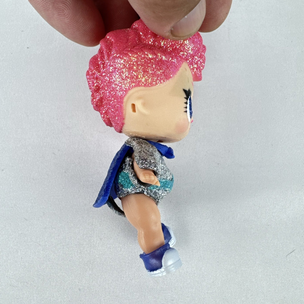 MGA Entertainment LOL Surprise Glitter Series Cosmic Queen 3-inch doll with pink glitter hair and cape