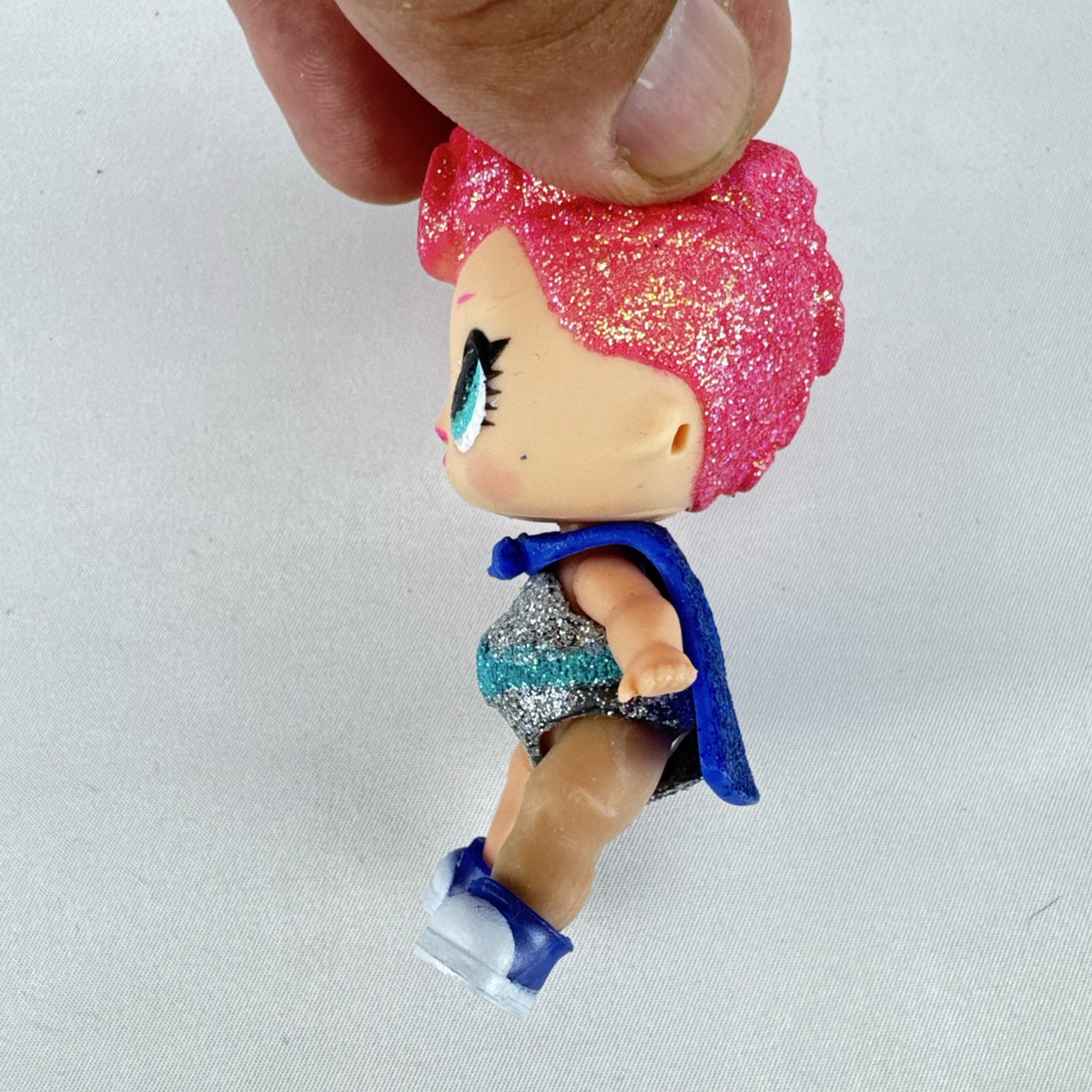 MGA Entertainment LOL Surprise Glitter Series Cosmic Queen 3-inch doll with pink glitter hair and cape
