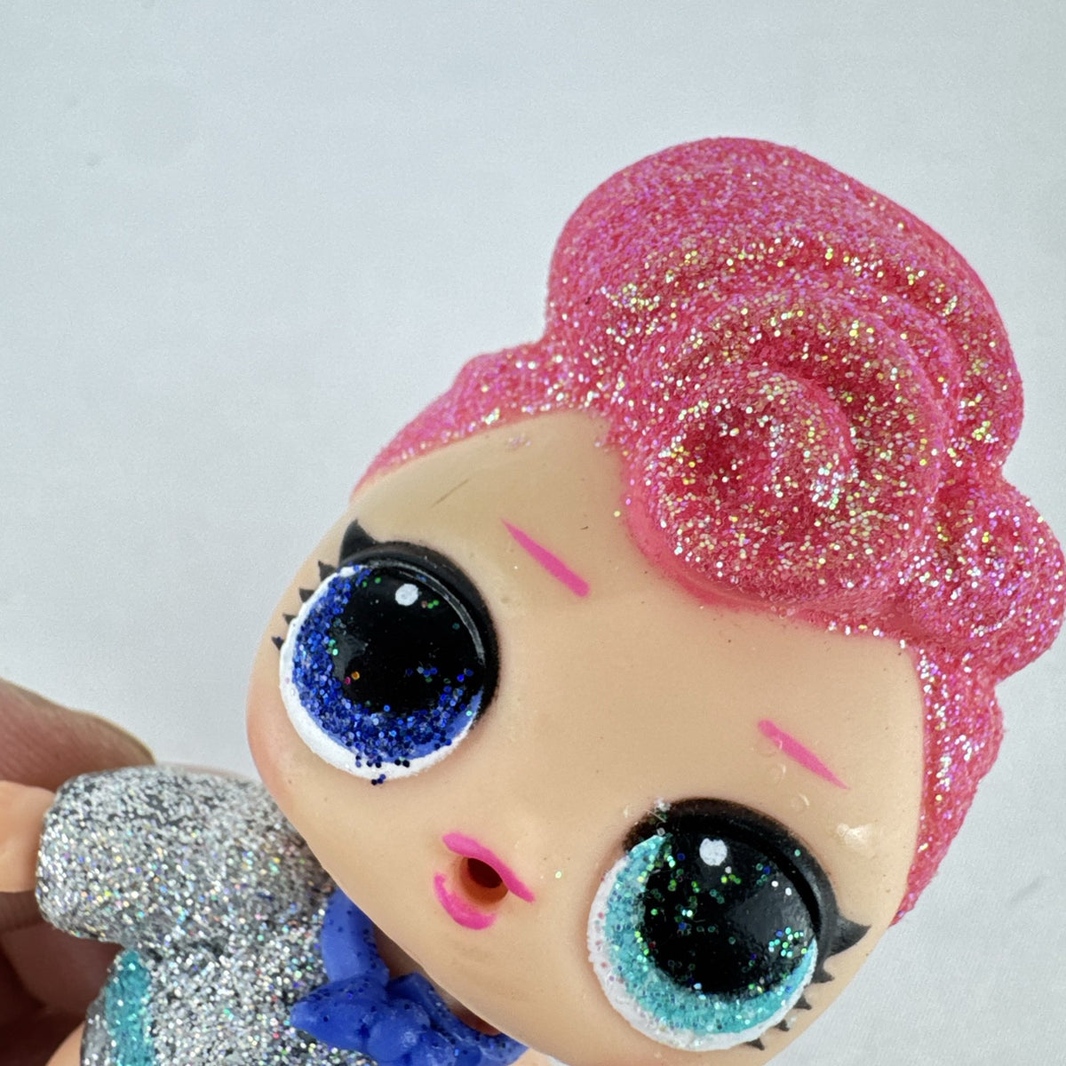 MGA Entertainment LOL Surprise Glitter Series Cosmic Queen 3-inch doll with pink glitter hair and cape