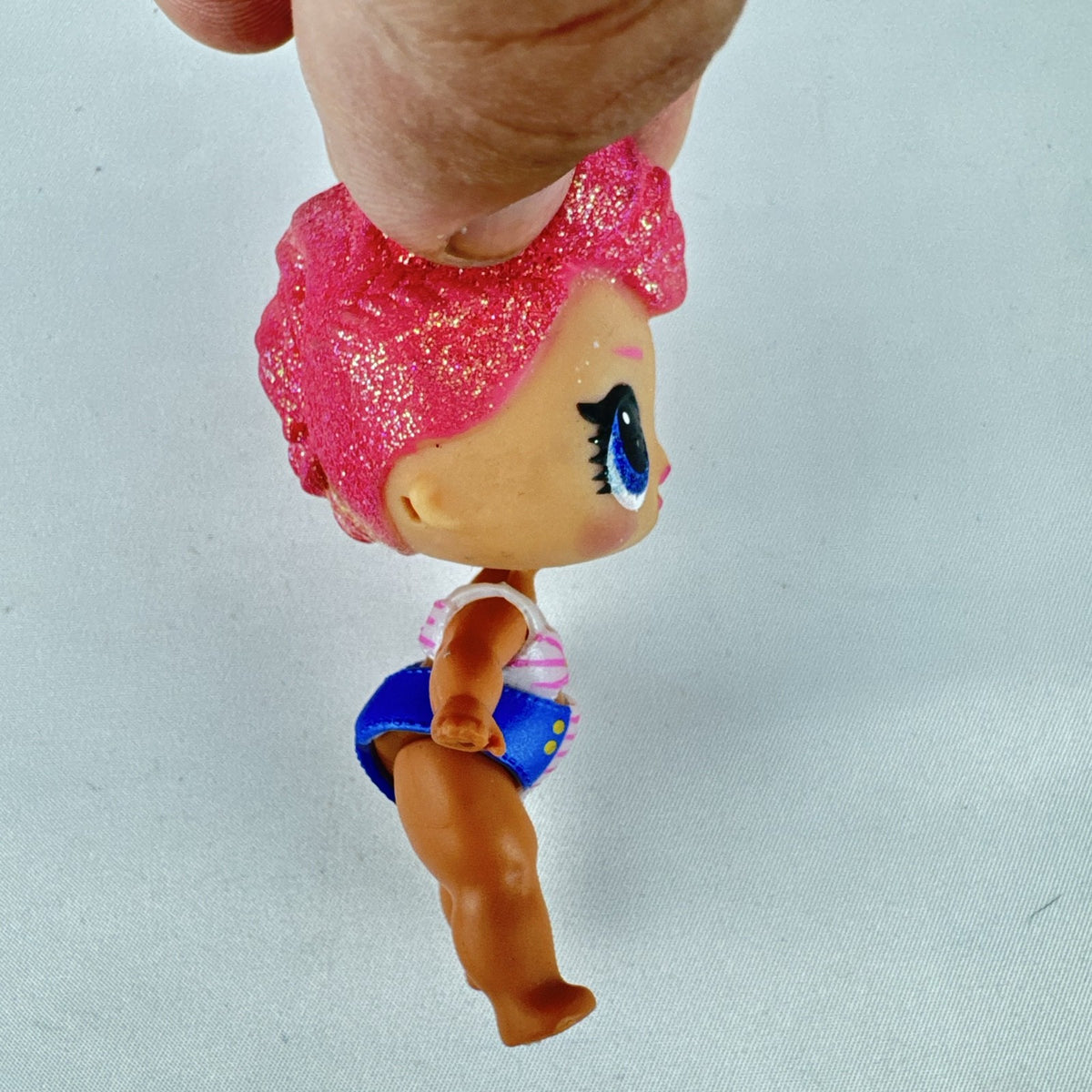 MGA L.O.L. Surprise High Dive doll with pink glitter hair and two-piece swimsuit
