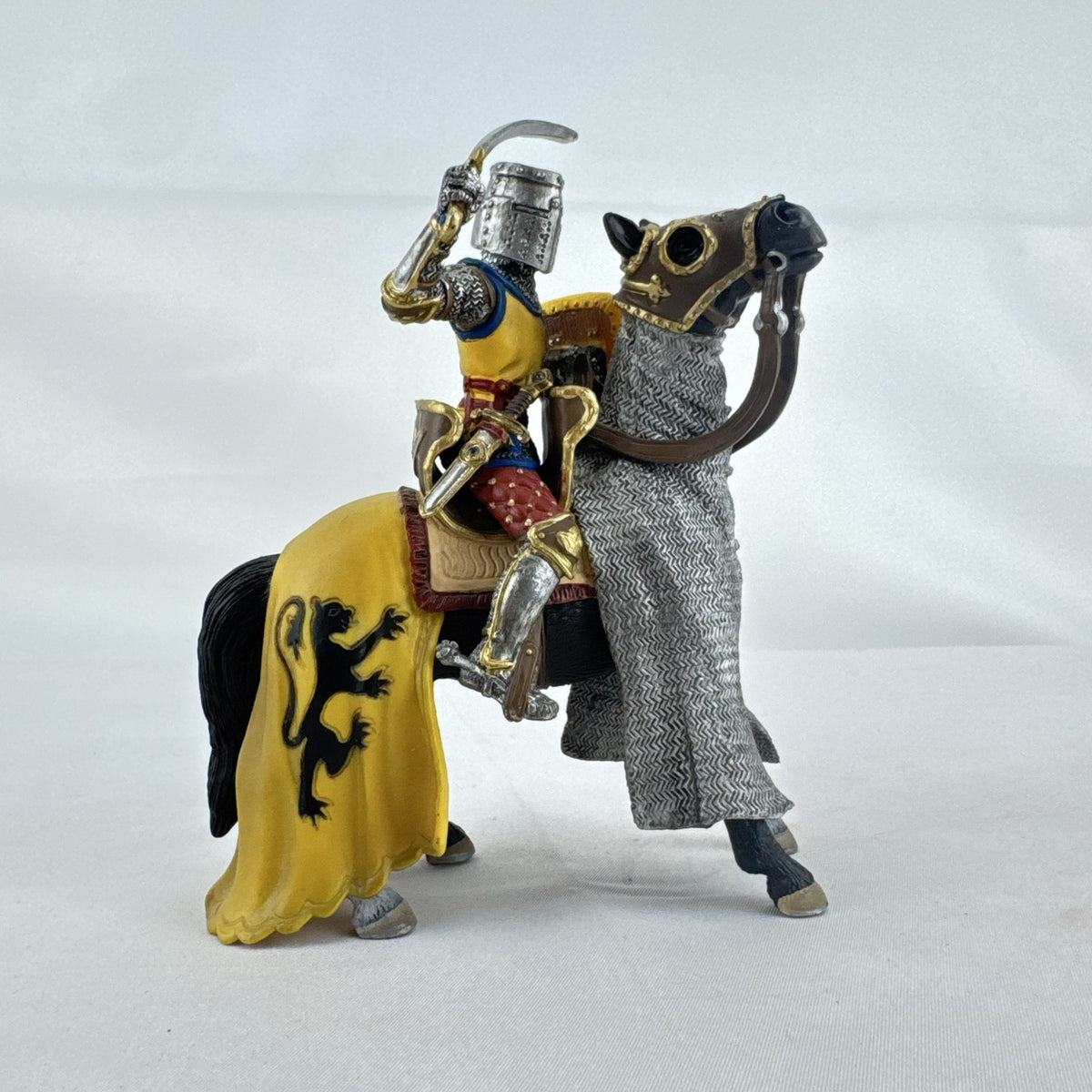 Schleich 2007 medieval knight figurine with sword and lion shield mounted on an armored warhorse