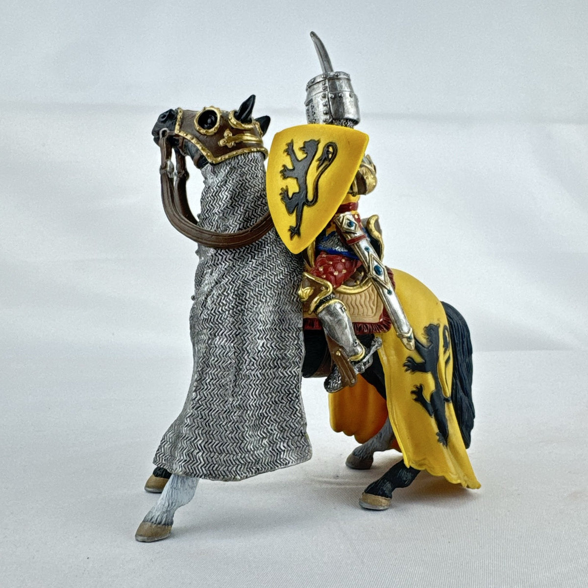 Schleich 2007 medieval knight figurine with sword and lion shield mounted on an armored warhorse