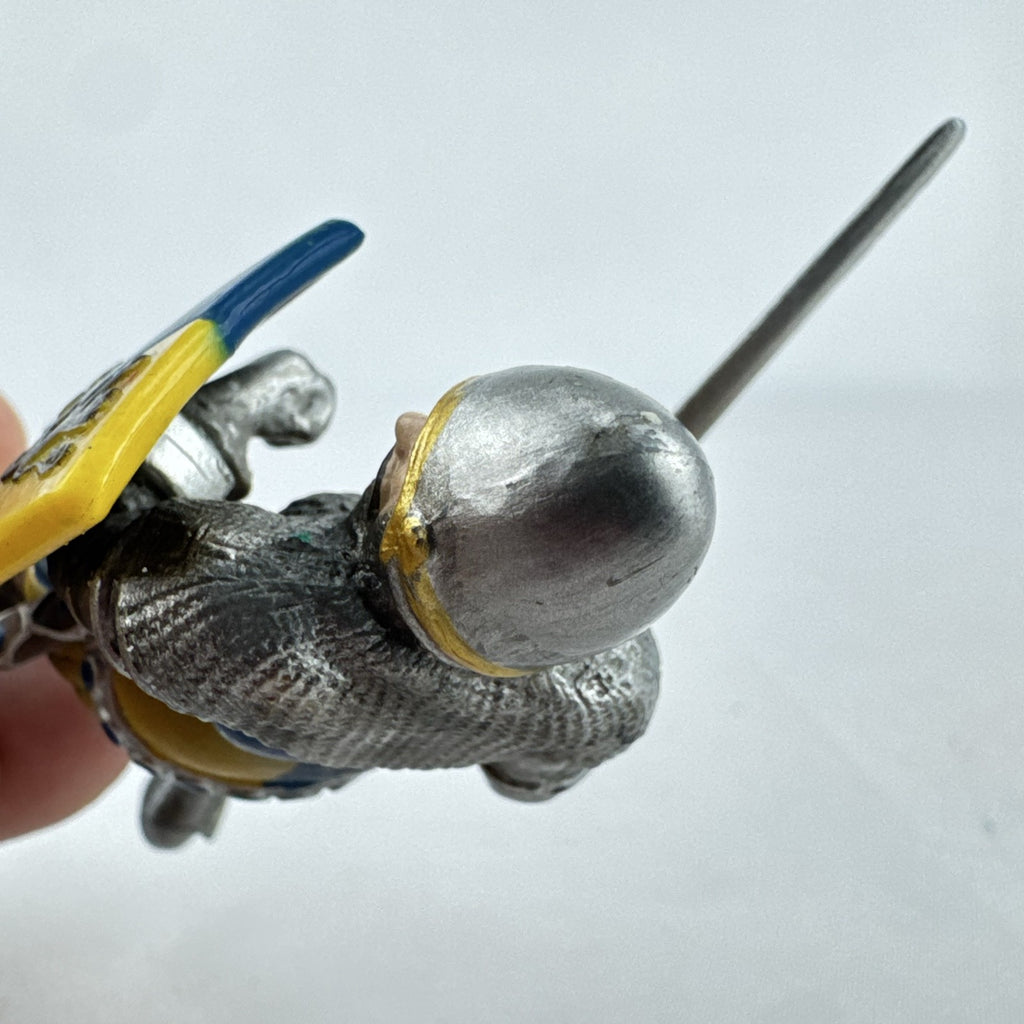 Schleich 2003 medieval knight foot soldier plastic figure holding a sword and blue and yellow lion shield