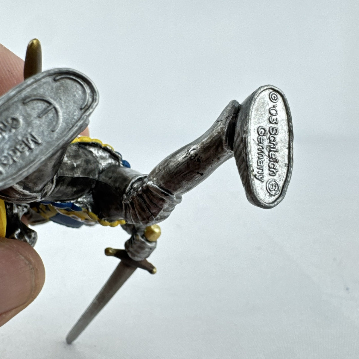Schleich 2003 medieval knight foot soldier plastic figure holding a sword and blue and yellow lion shield