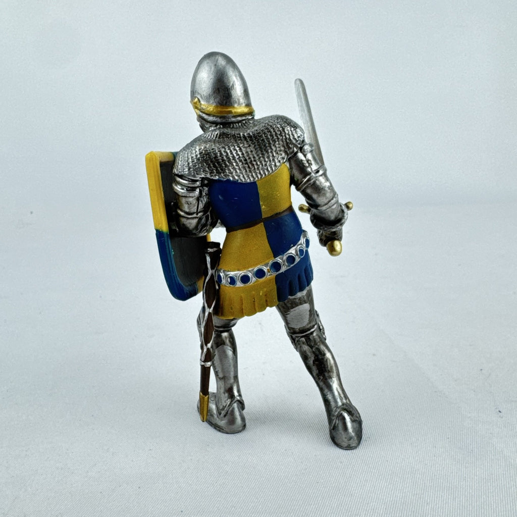 Schleich 2003 medieval knight foot soldier plastic figure holding a sword and blue and yellow lion shield