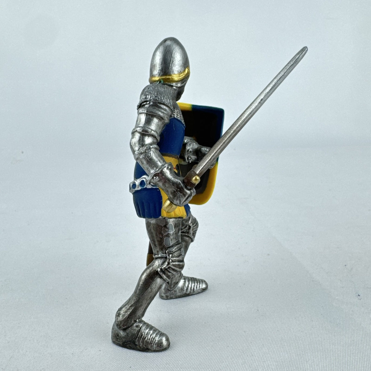 Schleich 2003 medieval knight foot soldier plastic figure holding a sword and blue and yellow lion shield