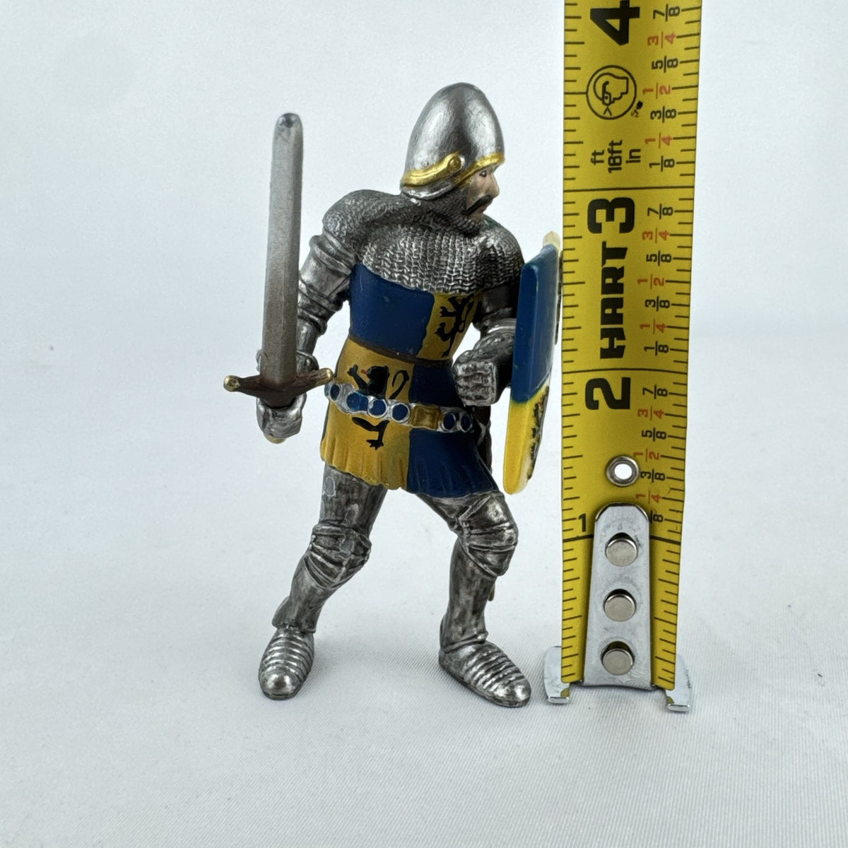 Schleich 2003 medieval knight foot soldier plastic figure holding a sword and blue and yellow lion shield