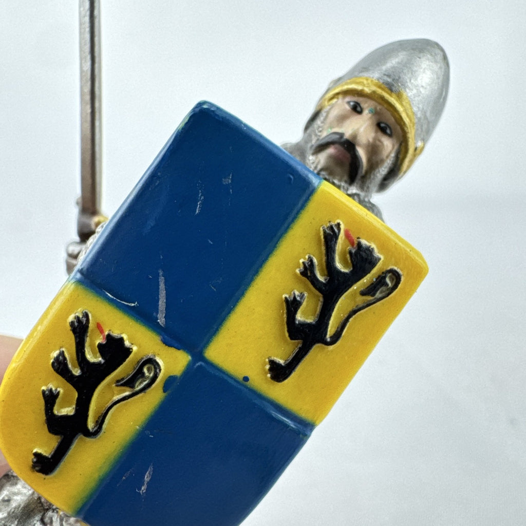 Schleich 2003 medieval knight foot soldier plastic figure holding a sword and blue and yellow lion shield