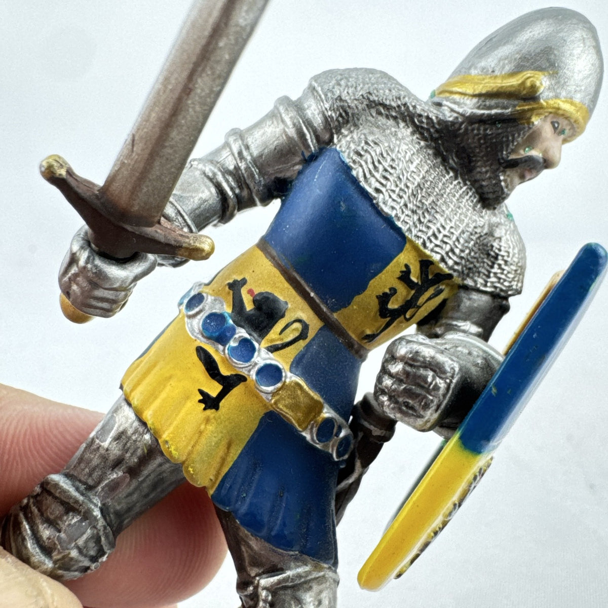 Schleich 2003 medieval knight foot soldier plastic figure holding a sword and blue and yellow lion shield