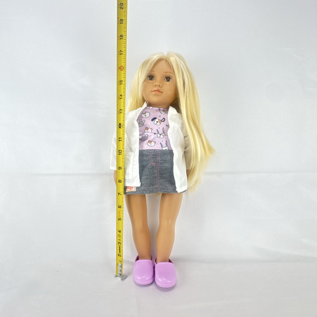 Our Generation Nicola 18-inch blonde veterinarian doll in white lab coat, patterned top, and purple shoes