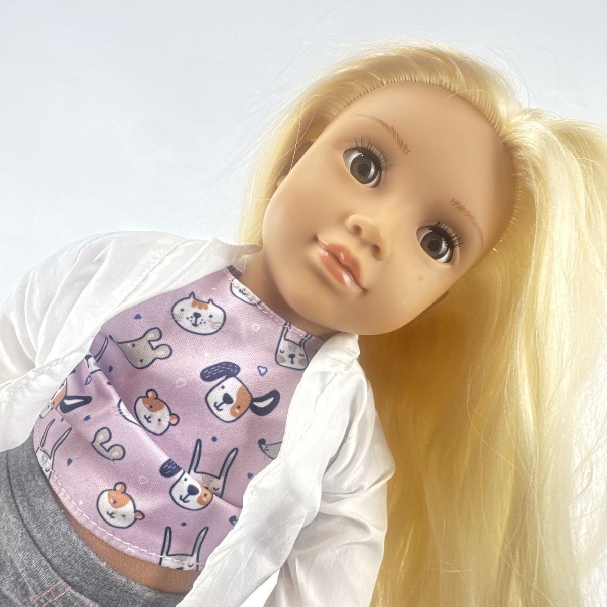 Our Generation Nicola 18-inch blonde veterinarian doll in white lab coat, patterned top, and purple shoes