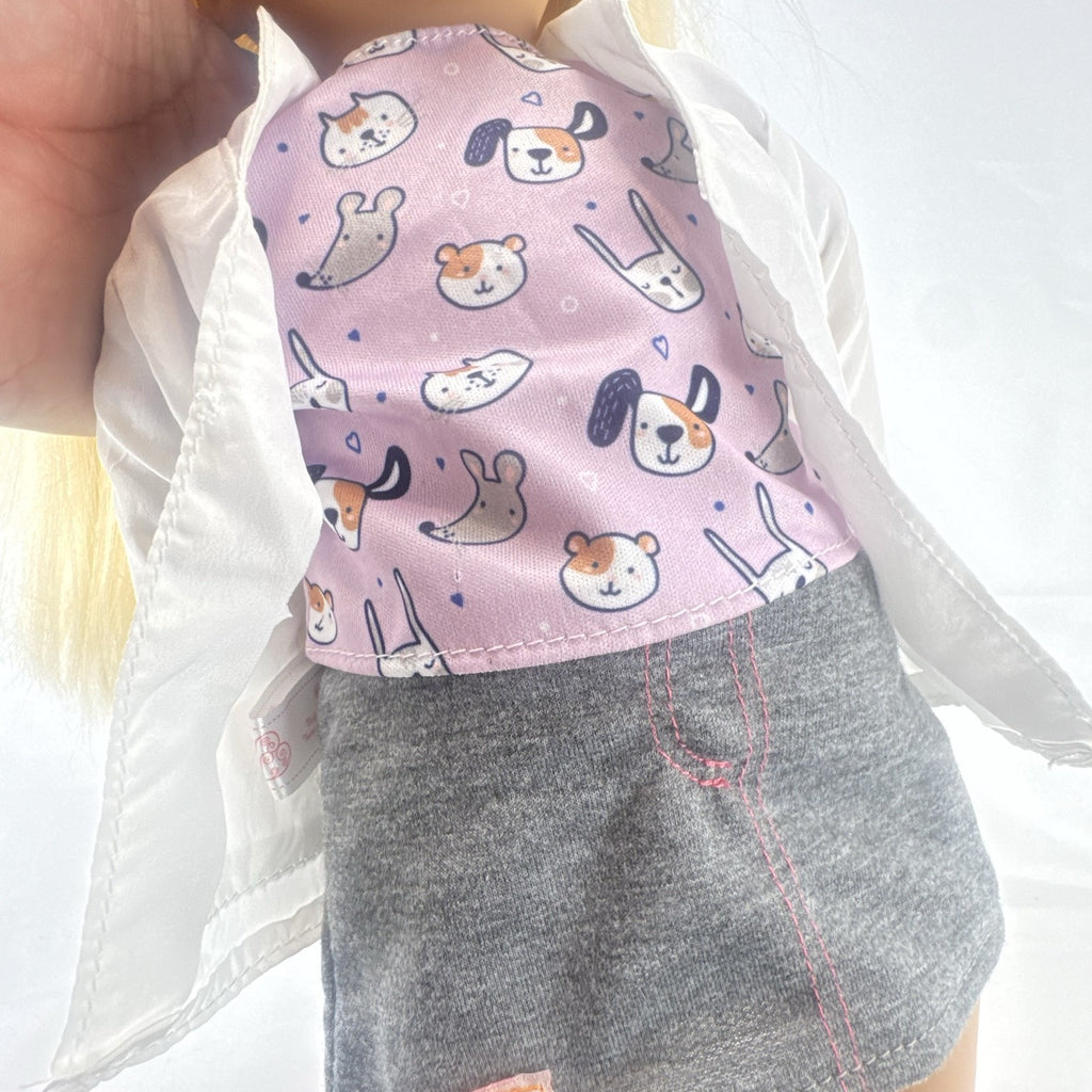 Our Generation Nicola 18-inch blonde veterinarian doll in white lab coat, patterned top, and purple shoes