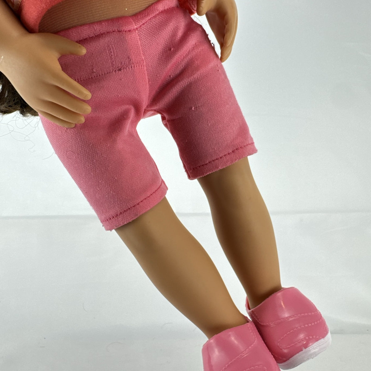 Battat Our Generation 18-inch doll with wavy brown hair, red striped shirt, and pink shorts