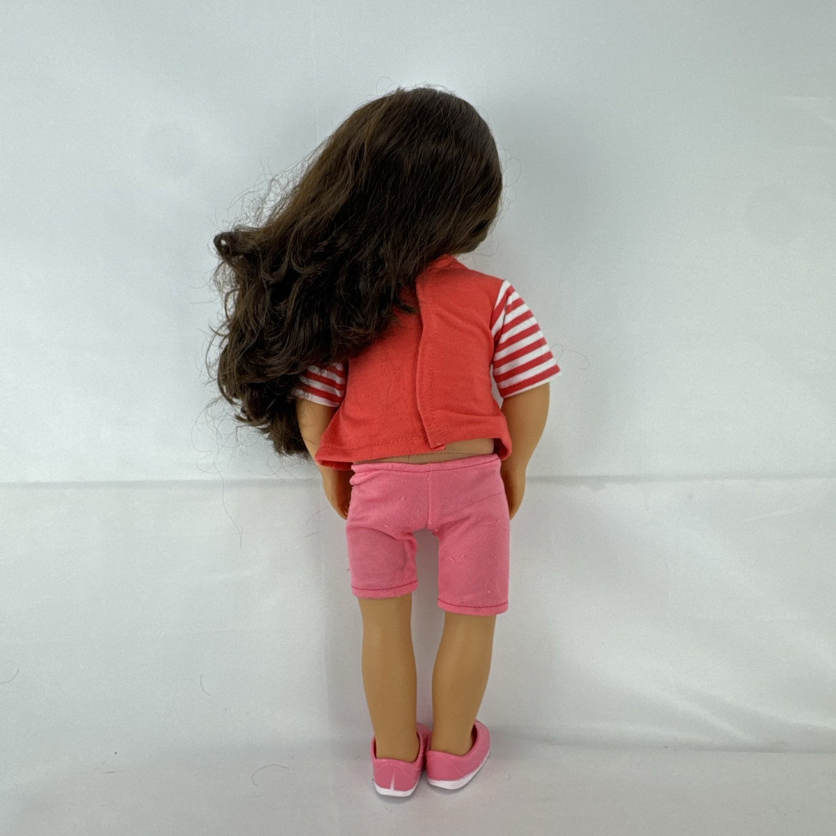 Battat Our Generation 18-inch doll with wavy brown hair, red striped shirt, and pink shorts