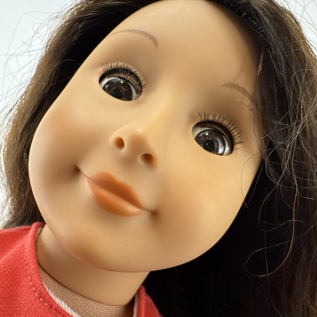 Battat Our Generation 18-inch doll with wavy brown hair, red striped shirt, and pink shorts