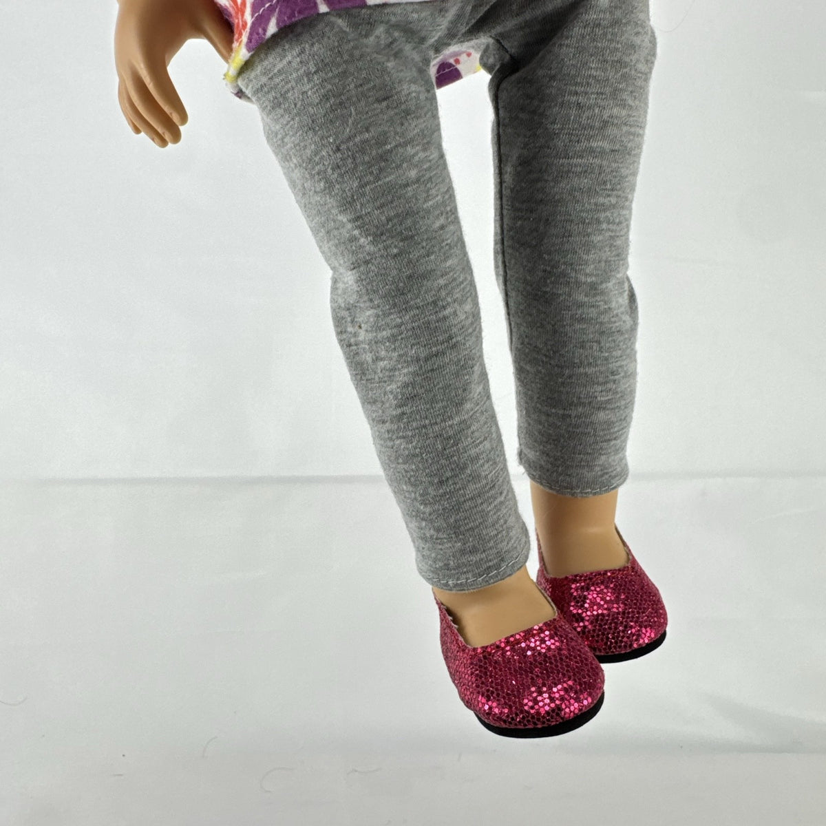Lovee Doll & Toy Co. 18-inch girl doll with blonde braids, blue eyes, floral top, and pink glitter flats