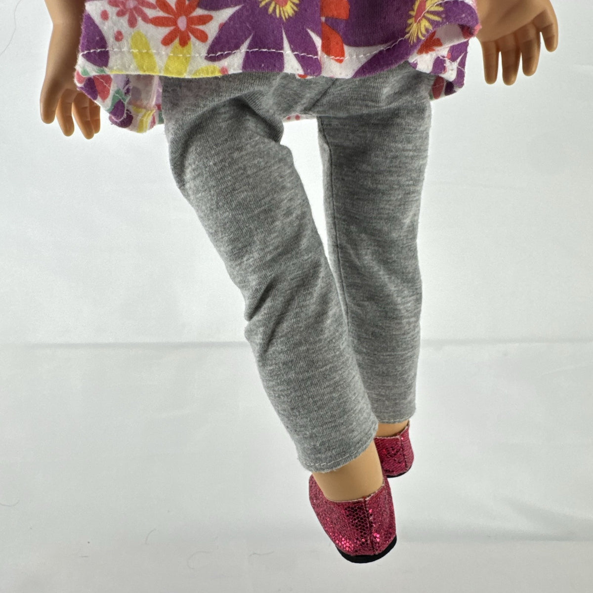 Lovee Doll & Toy Co. 18-inch girl doll with blonde braids, blue eyes, floral top, and pink glitter flats