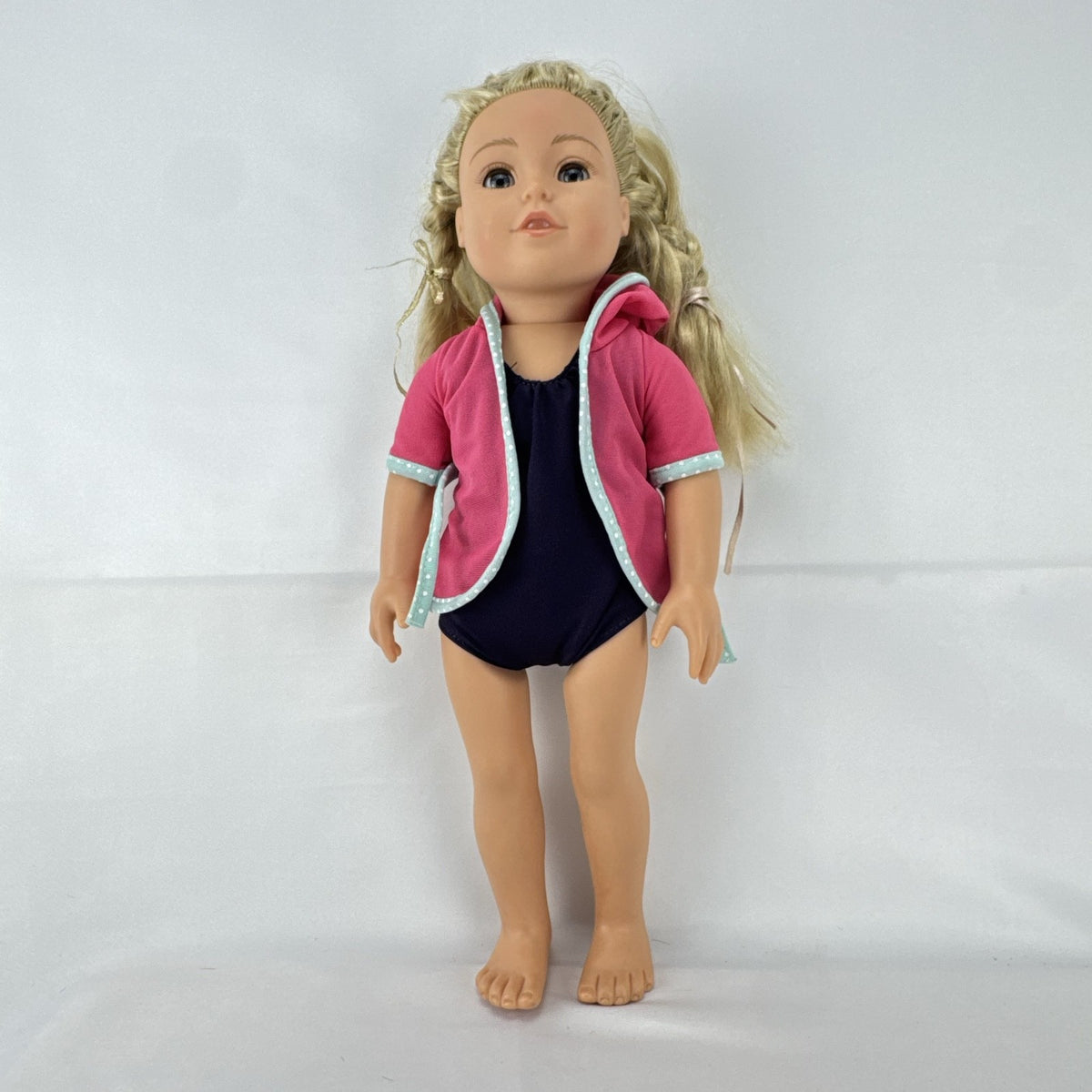 Adora 18-inch blonde doll with blue eyes wearing a navy swimsuit and pink polka dot hooded cover-up