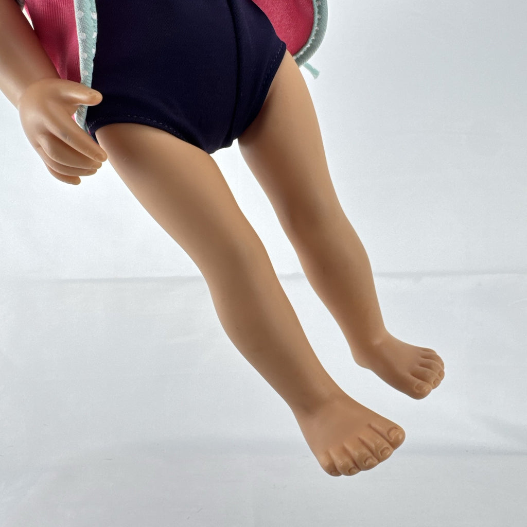 Adora 18-inch blonde doll with blue eyes wearing a navy swimsuit and pink polka dot hooded cover-up