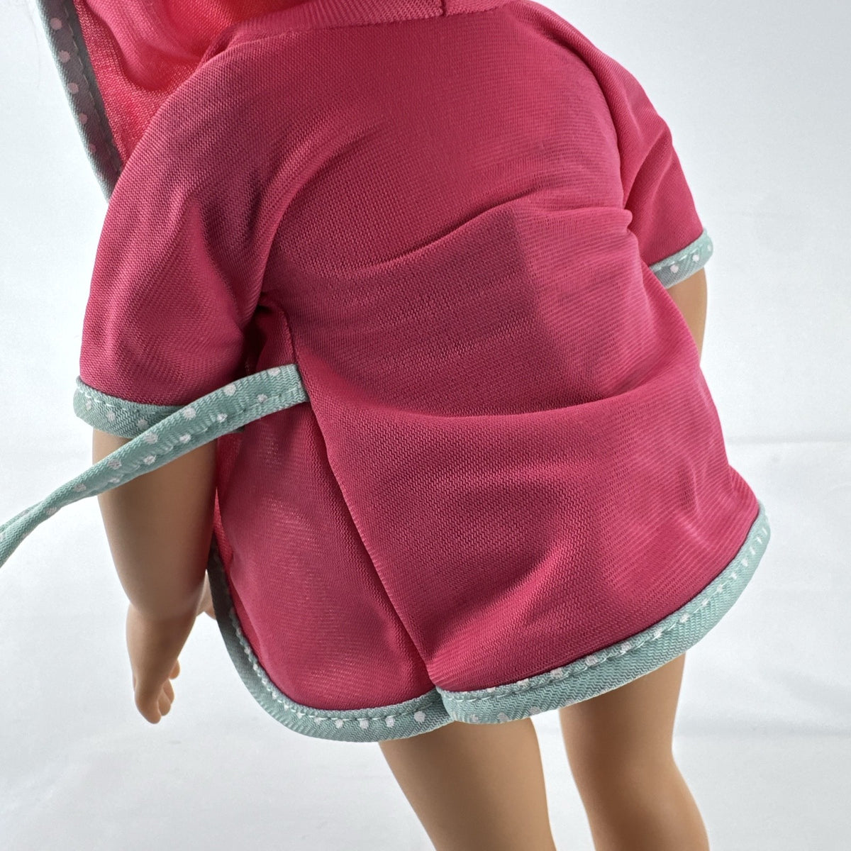 Adora 18-inch blonde doll with blue eyes wearing a navy swimsuit and pink polka dot hooded cover-up
