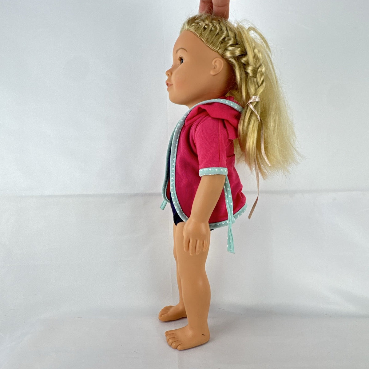 Adora 18-inch blonde doll with blue eyes wearing a navy swimsuit and pink polka dot hooded cover-up