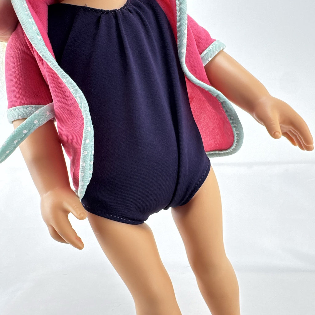Adora 18-inch blonde doll with blue eyes wearing a navy swimsuit and pink polka dot hooded cover-up