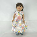 Madame Alexander 18-inch vinyl girl doll with brown ponytail, blue eyes, butterfly floral dress, and glitter shoes