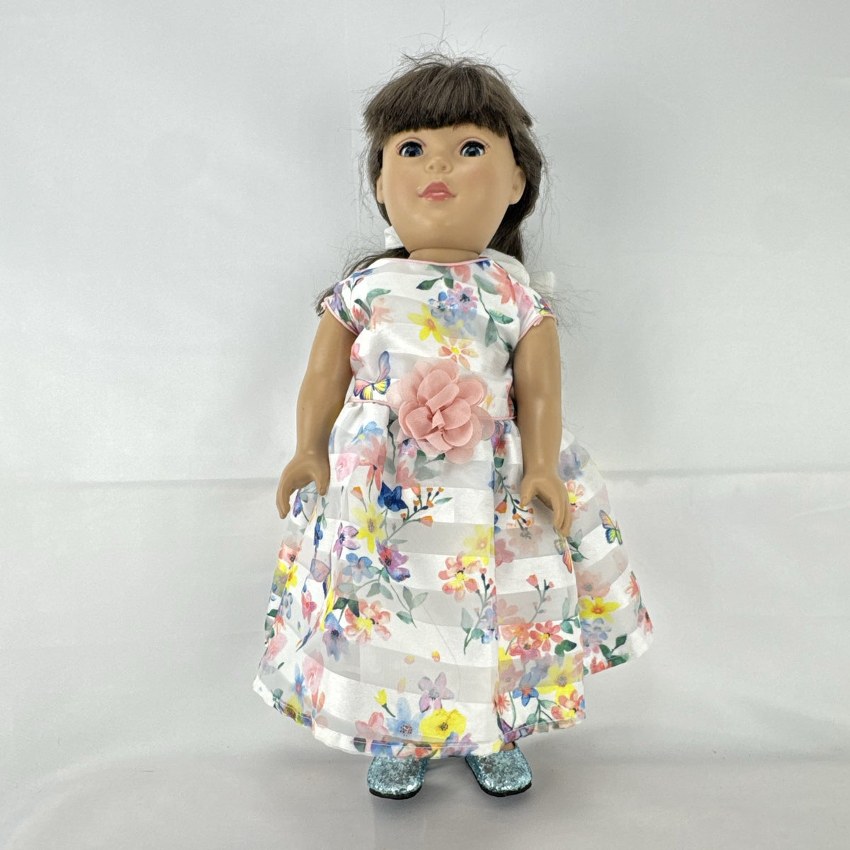 Madame Alexander 18-inch vinyl girl doll with brown ponytail, blue eyes, butterfly floral dress, and glitter shoes