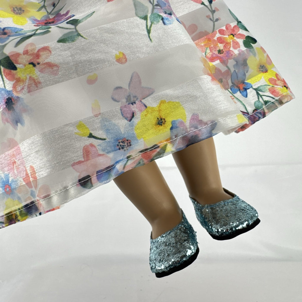 Madame Alexander 18-inch vinyl girl doll with brown ponytail, blue eyes, butterfly floral dress, and glitter shoes
