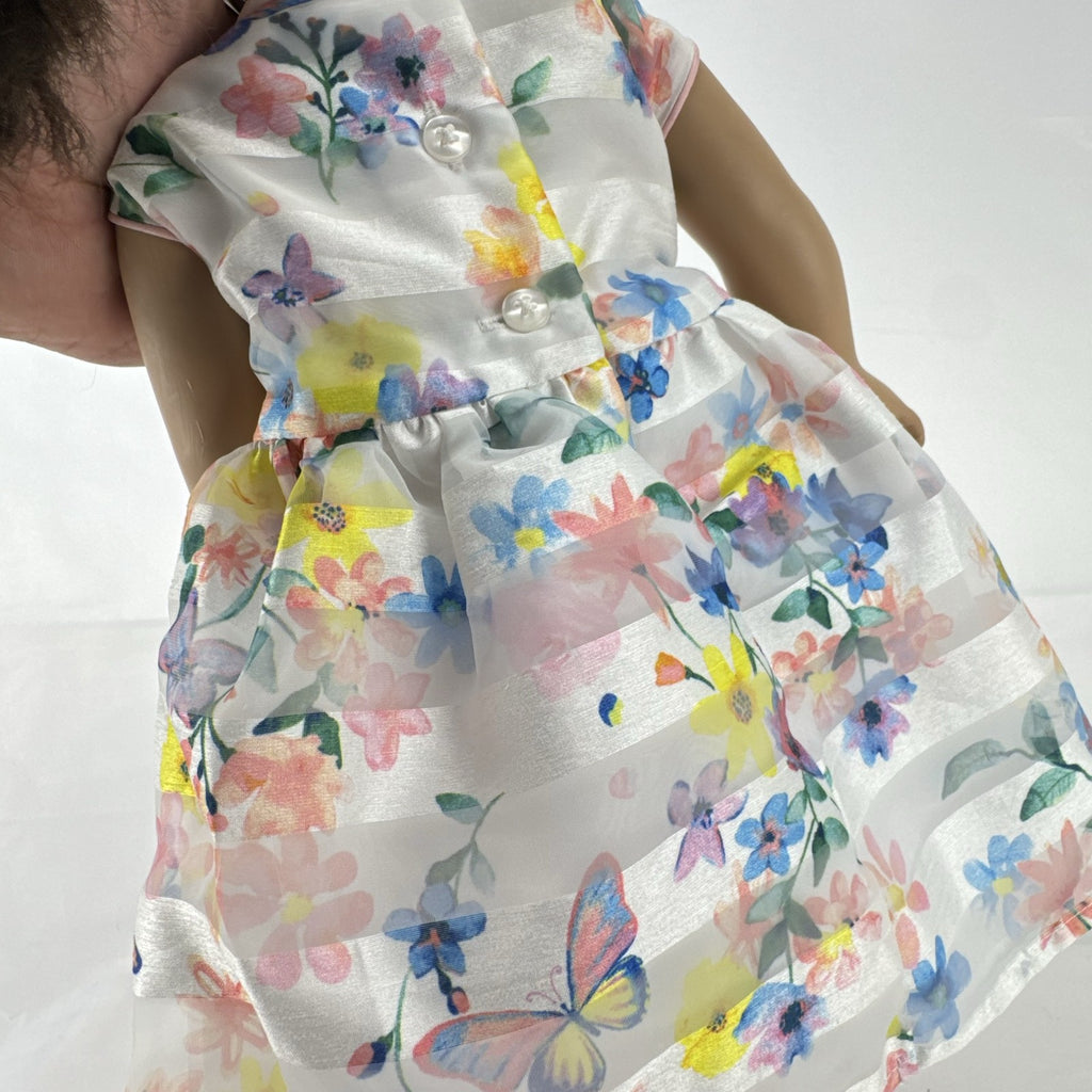 Madame Alexander 18-inch vinyl girl doll with brown ponytail, blue eyes, butterfly floral dress, and glitter shoes