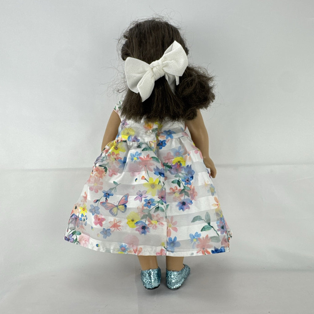 Madame Alexander 18-inch vinyl girl doll with brown ponytail, blue eyes, butterfly floral dress, and glitter shoes