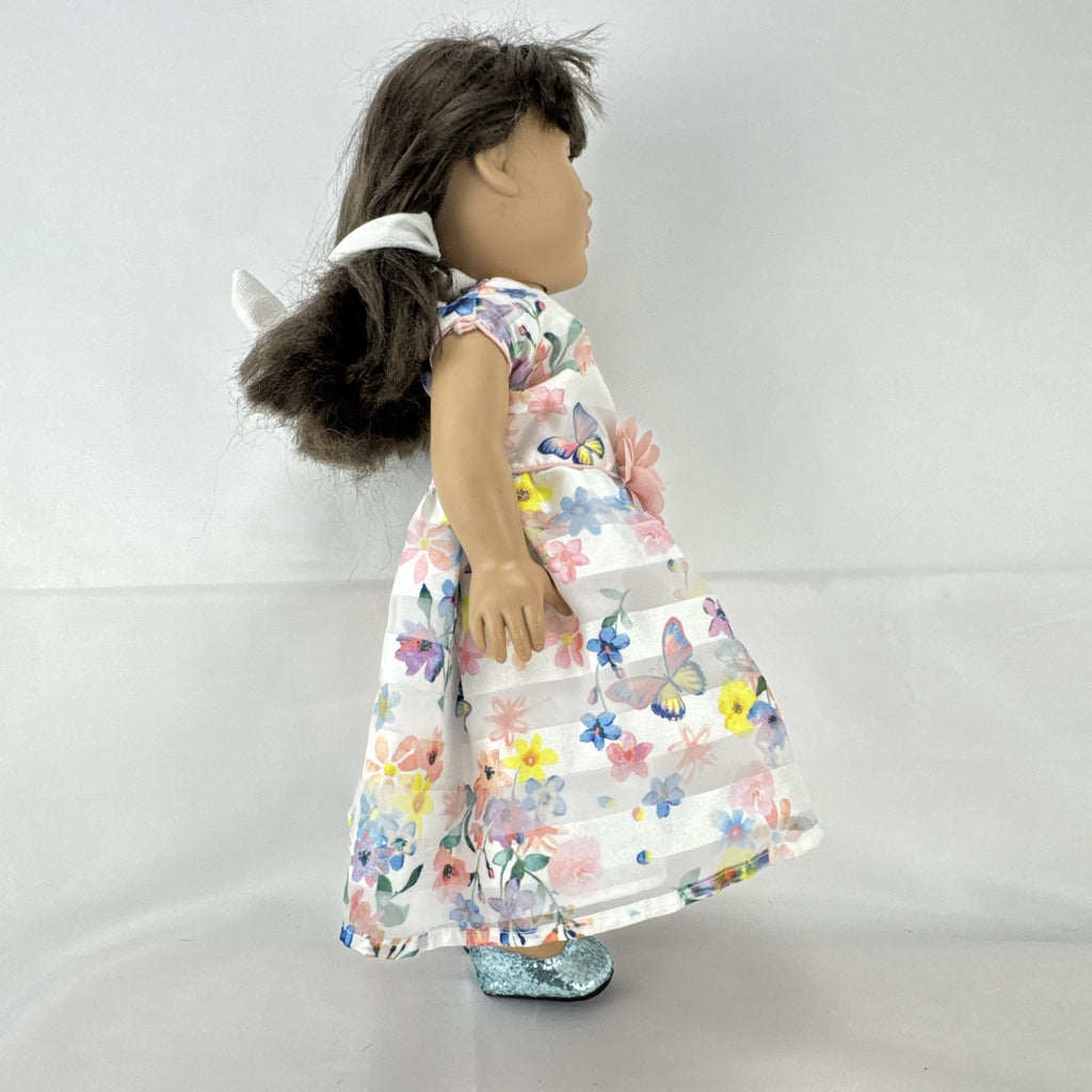 Madame Alexander 18-inch vinyl girl doll with brown ponytail, blue eyes, butterfly floral dress, and glitter shoes