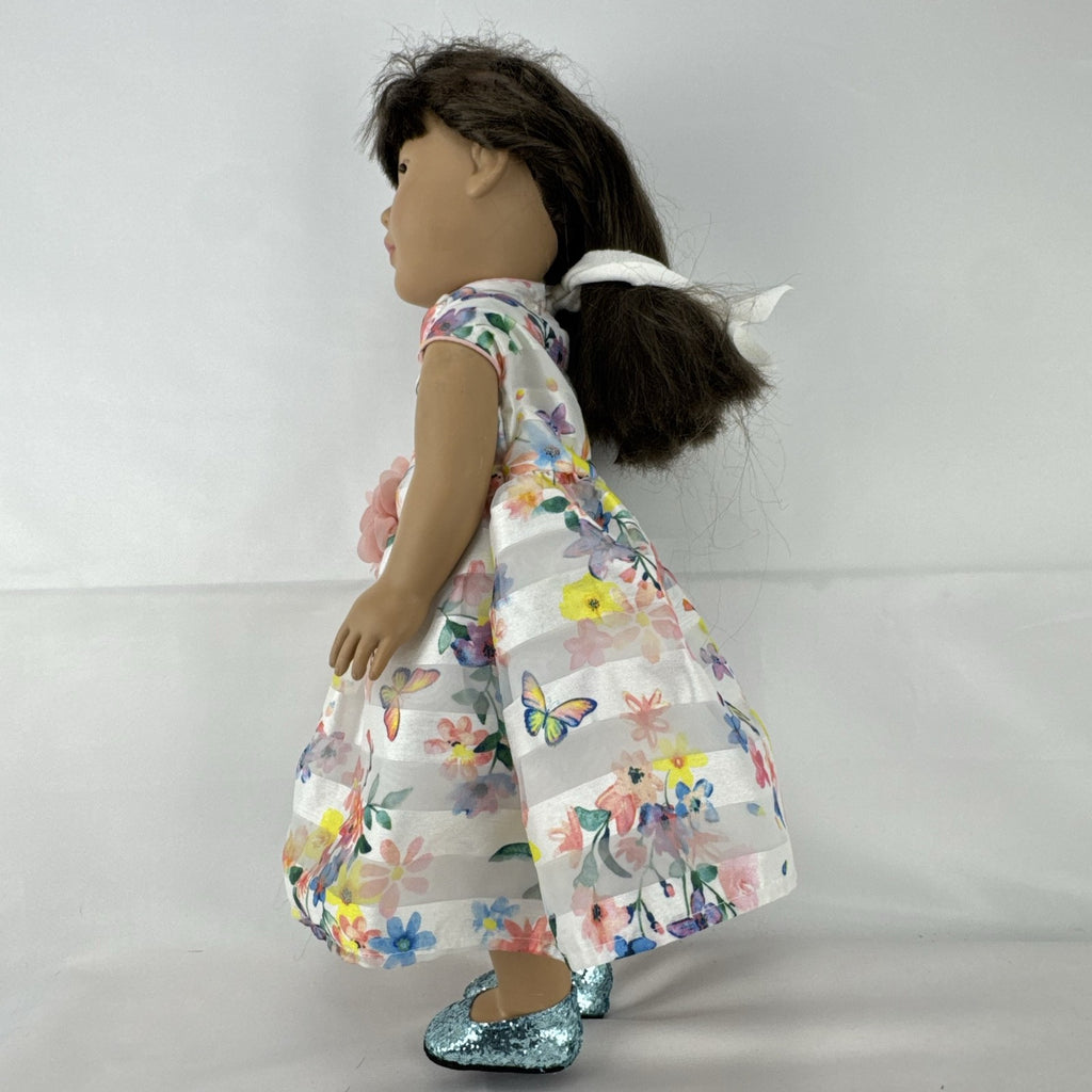 Madame Alexander 18-inch vinyl girl doll with brown ponytail, blue eyes, butterfly floral dress, and glitter shoes