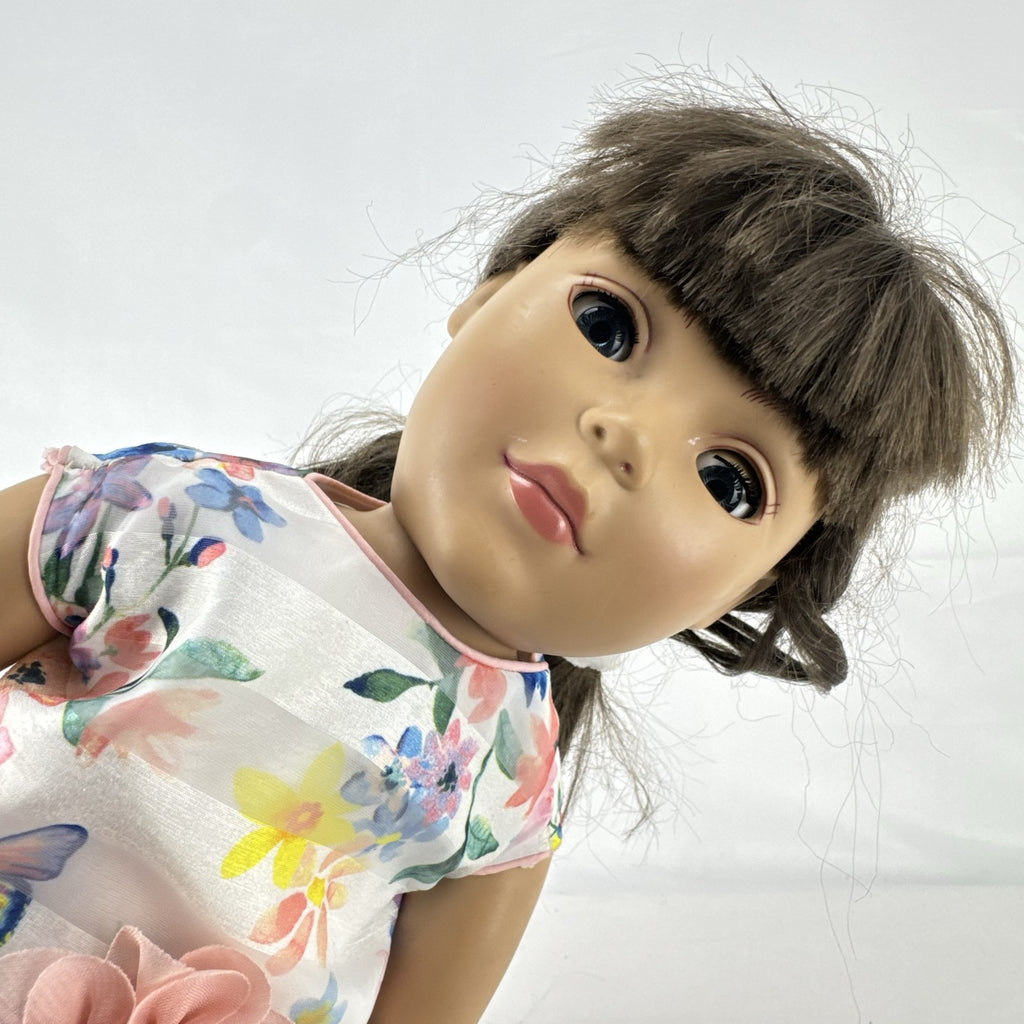 Madame Alexander 18-inch vinyl girl doll with brown ponytail, blue eyes, butterfly floral dress, and glitter shoes
