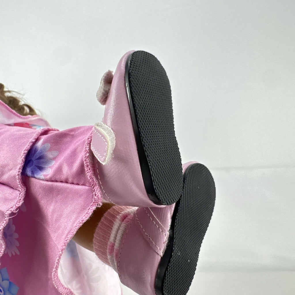 Battat Our Generation 18-inch girl doll with wavy brown hair wearing a pink floral tiered dress and bow shoes