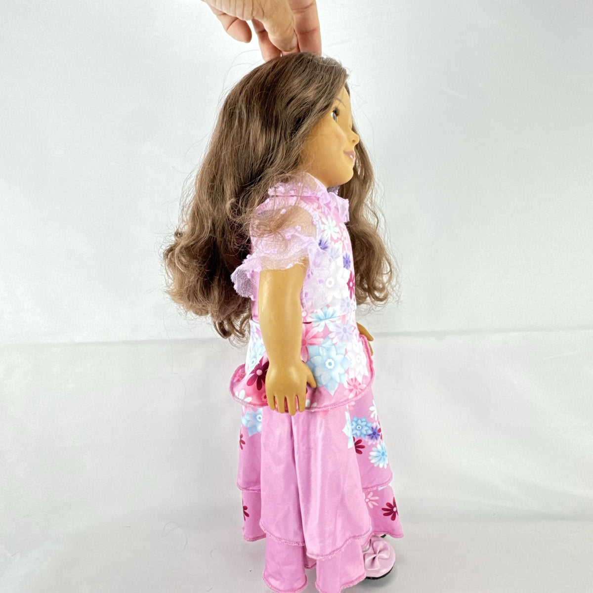 Battat Our Generation 18-inch girl doll with wavy brown hair wearing a pink floral tiered dress and bow shoes