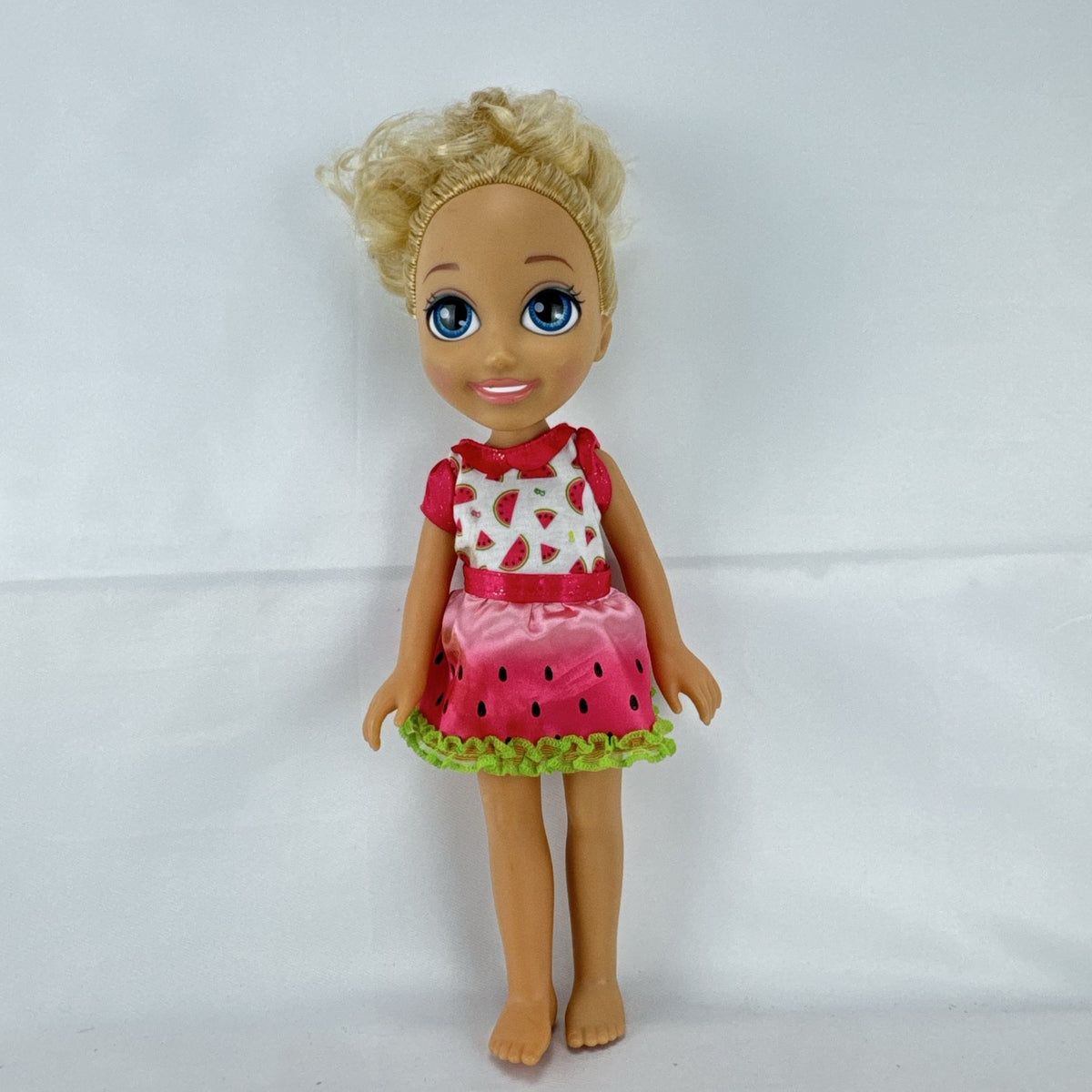 Mattel Barbie 14-inch blonde toddler play doll wearing a watermelon dress with green trim