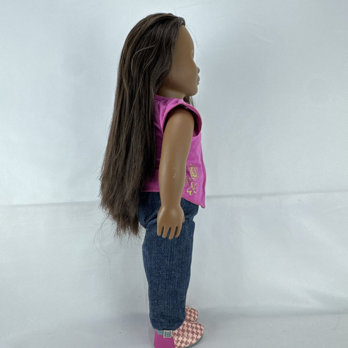 Our Generation 18-inch African American doll in pink wrap top and denim pants with long dark brown hair