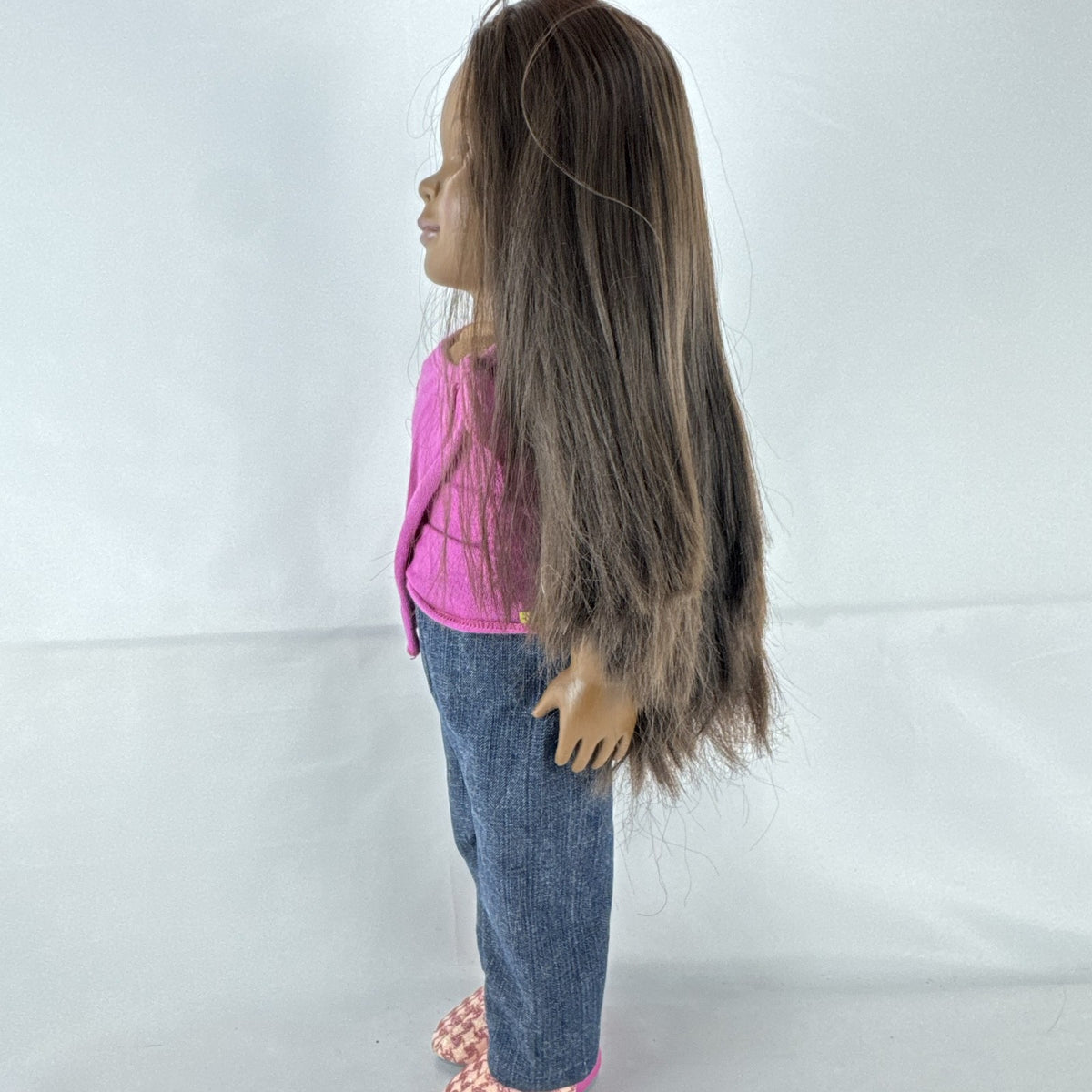 Our Generation 18-inch African American doll in pink wrap top and denim pants with long dark brown hair