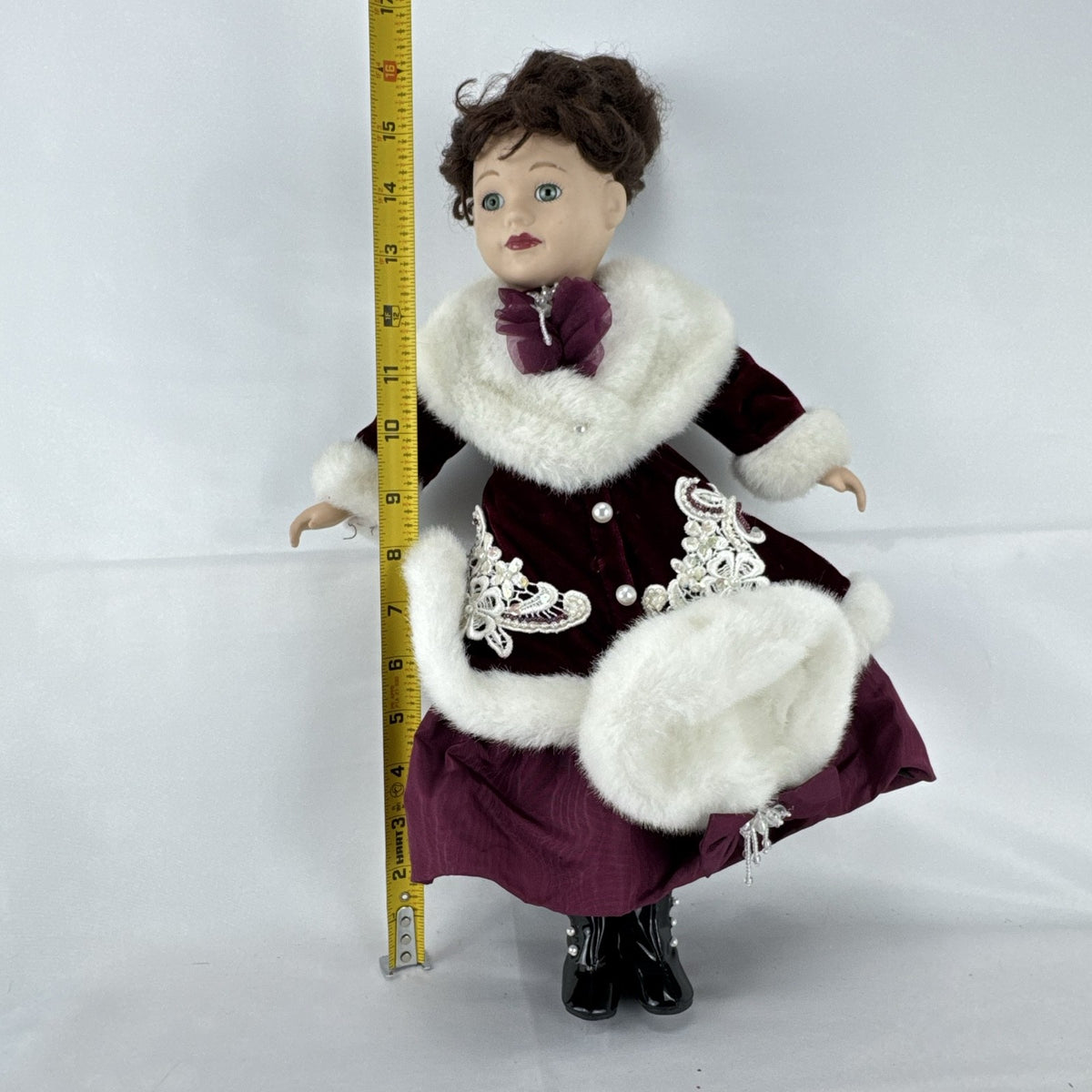 The Brass Key 15-inch Victorian porcelain doll in burgundy velvet winter coat with white faux fur trim and muff