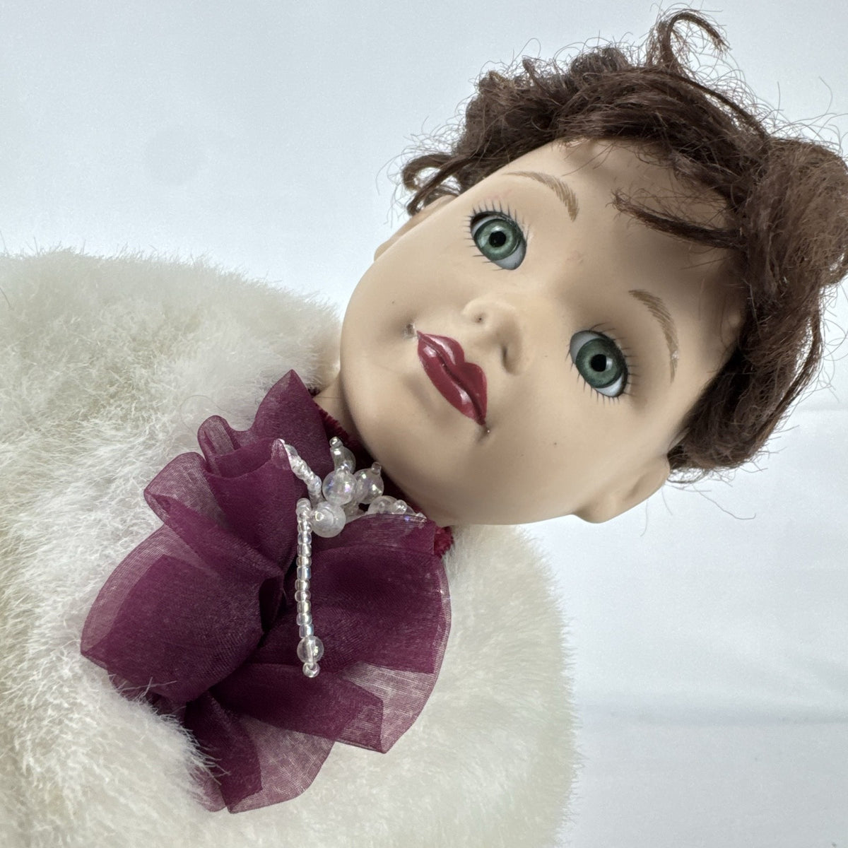 The Brass Key 15-inch Victorian porcelain doll in burgundy velvet winter coat with white faux fur trim and muff