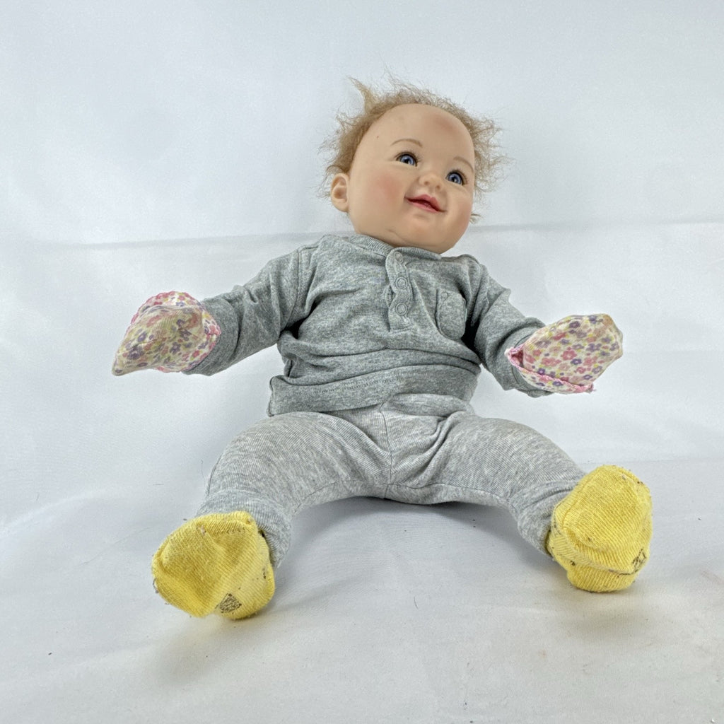 The Ashton-Drake Galleries 16-inch vinyl reborn baby doll sculpted by Ping Lau in grey loungewear