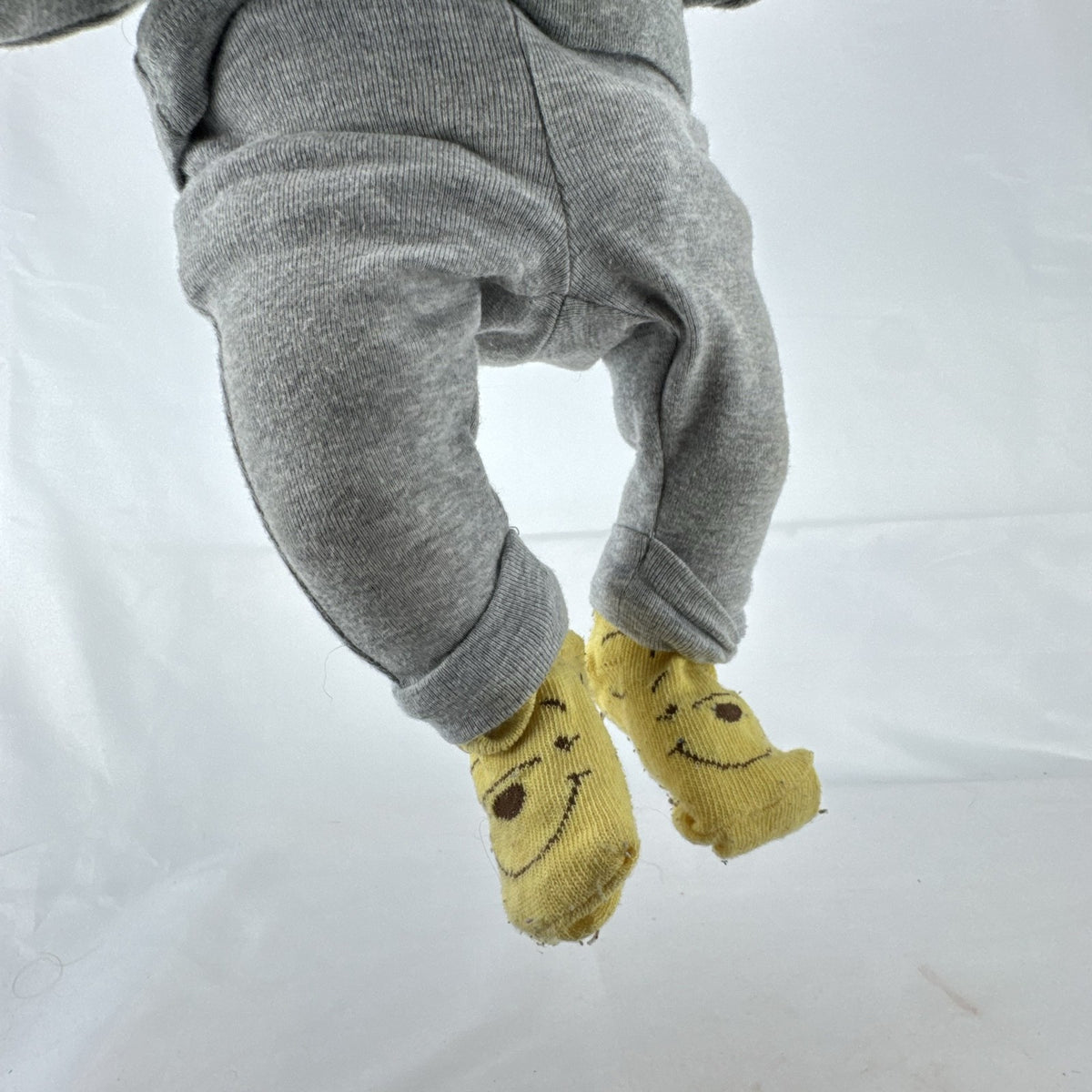 The Ashton-Drake Galleries 16-inch vinyl reborn baby doll sculpted by Ping Lau in grey loungewear