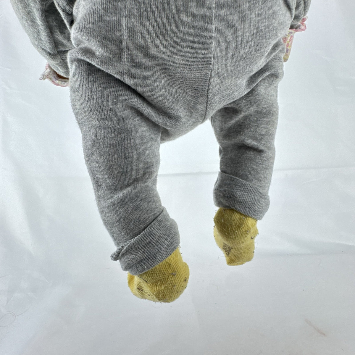 The Ashton-Drake Galleries 16-inch vinyl reborn baby doll sculpted by Ping Lau in grey loungewear