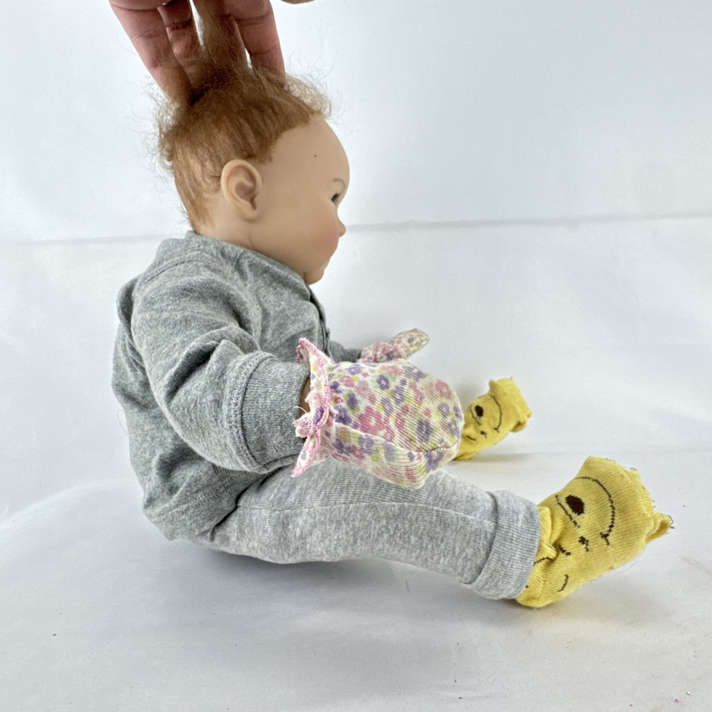 The Ashton-Drake Galleries 16-inch vinyl reborn baby doll sculpted by Ping Lau in grey loungewear
