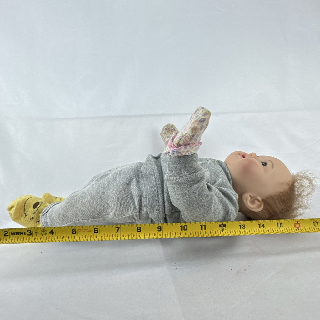 The Ashton-Drake Galleries 16-inch vinyl reborn baby doll sculpted by Ping Lau in grey loungewear