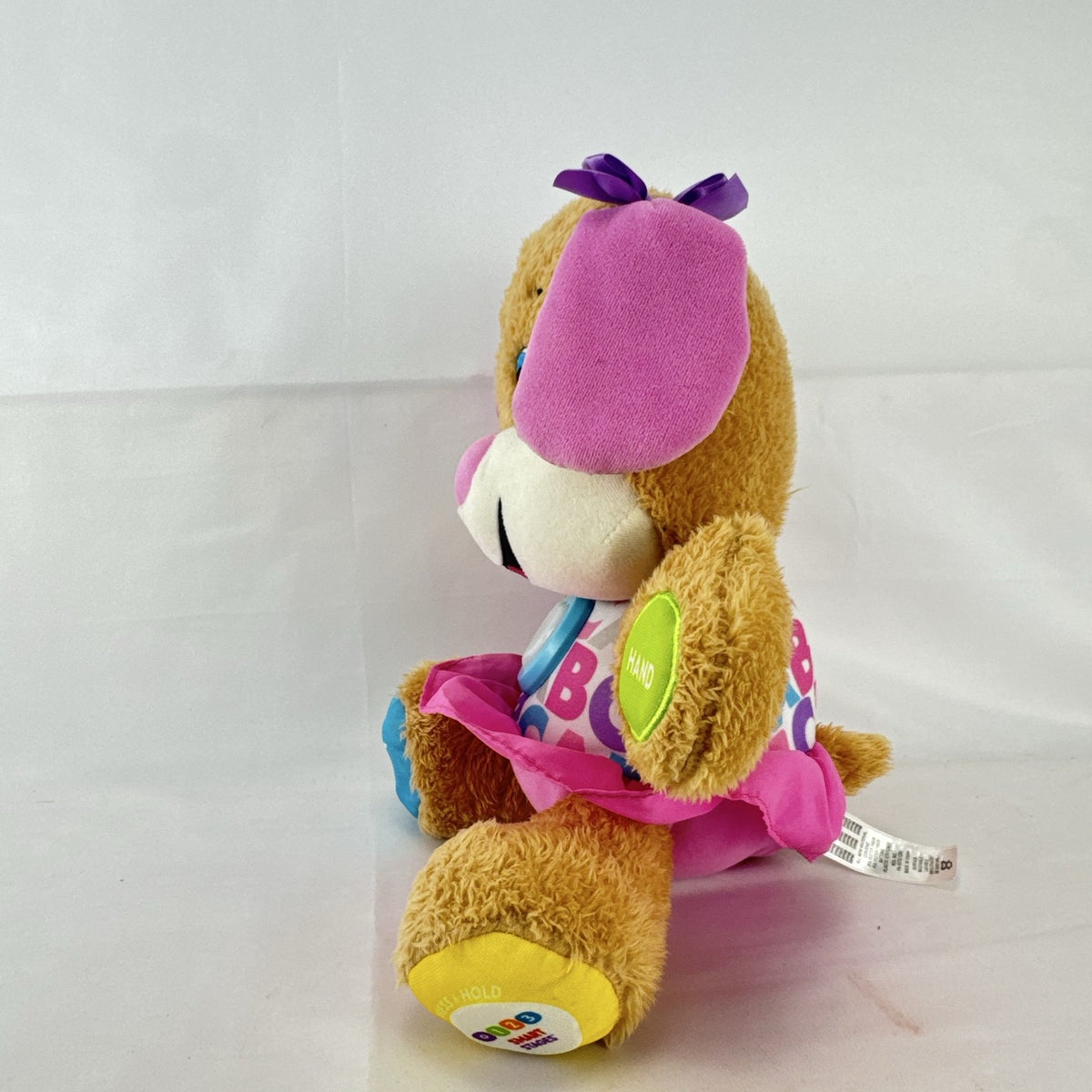 Fisher-Price Smart Stages Sis musical puppy plush toy in colorful alphabet dress