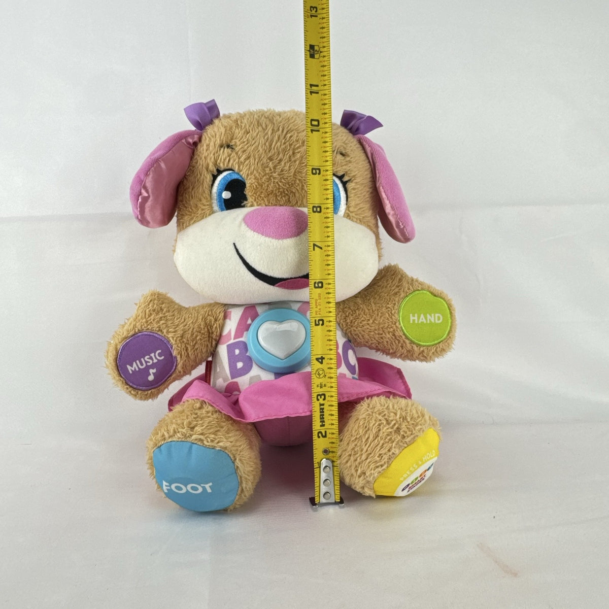 Fisher-Price Smart Stages Sis musical puppy plush toy in colorful alphabet dress